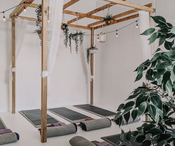 A serene and minimalist studio space designed for yoga and conscious movement.